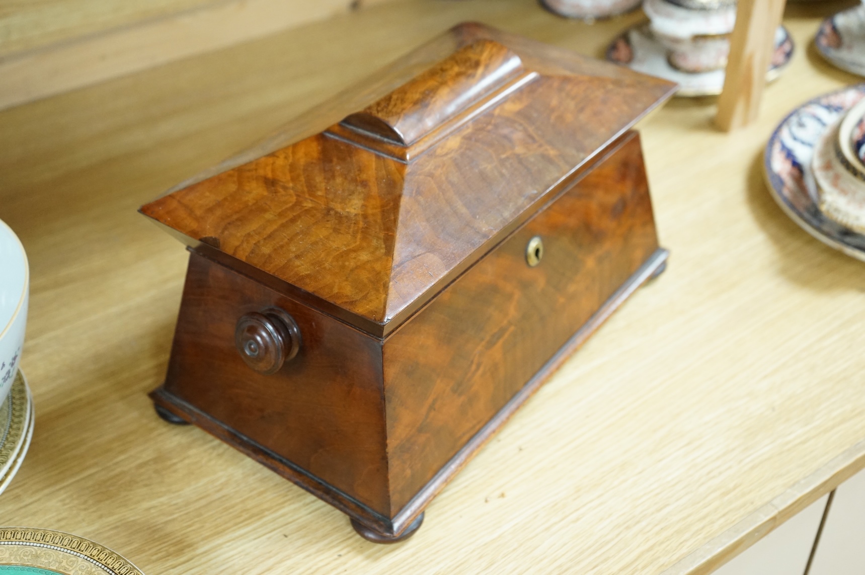 An early Victorian mahogany sarcophagus shaped tea caddy, 35cm wide